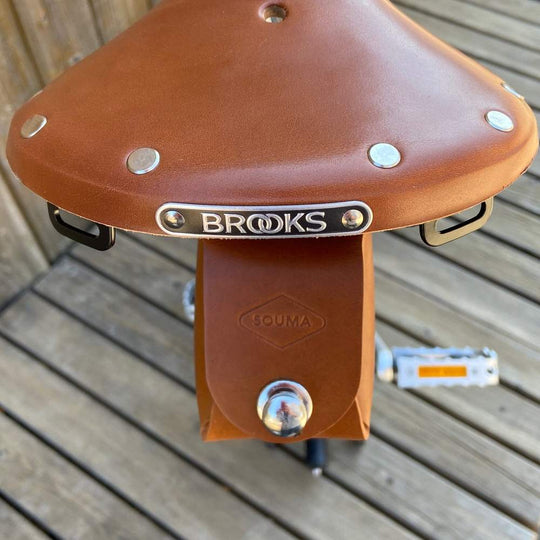 Honey bicycle saddle bag with silver hardware closure close-up