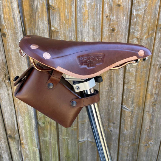 Brown bicycle saddle bag with black hardware sideview normal size