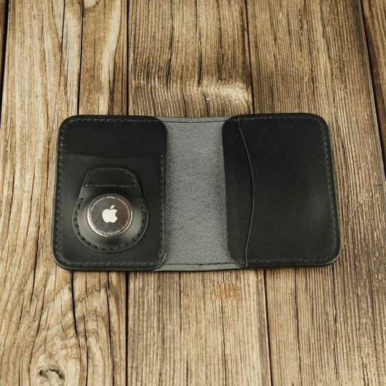 Black leather bifold wallet with slot on Apple AirTag slot inside view