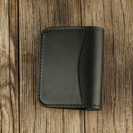Black leather bifold wallet with slot on Apple AirTag black side view