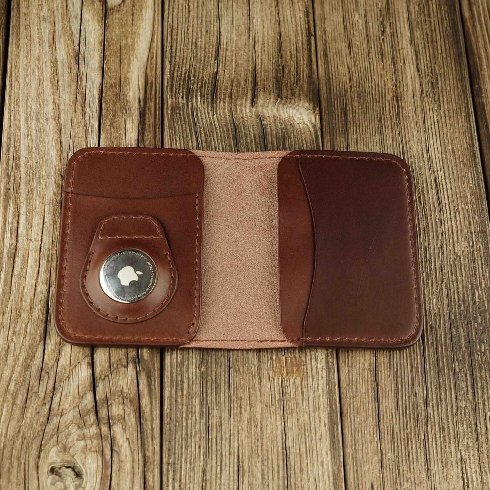 Brown leather bifold wallet with slot on Apple AirTag slot inside view
