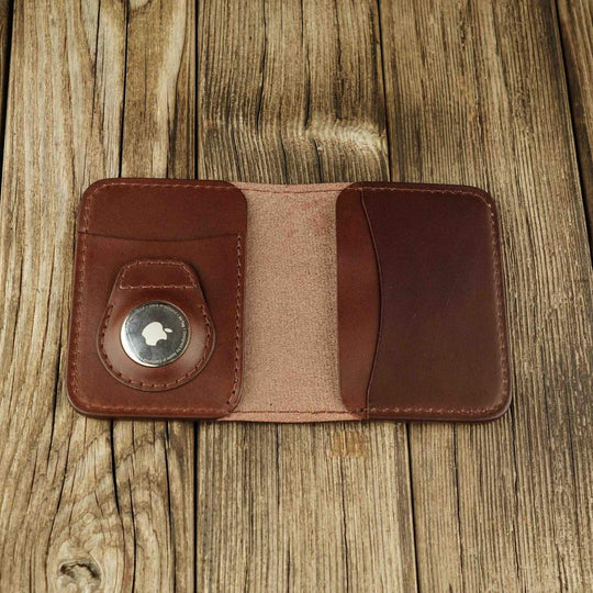 Brown leather bifold wallet with slot on Apple AirTag slot inside view
