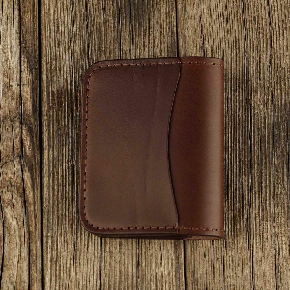 Brown leather bifold wallet with slot on Apple AirTag back view