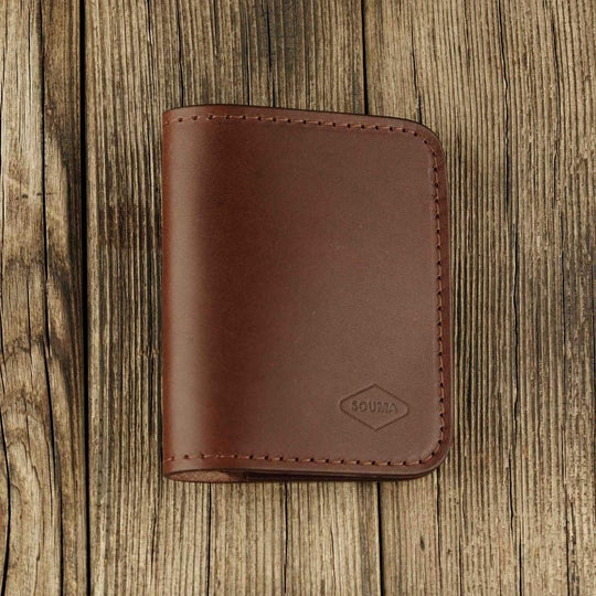 Brown leather bifold wallet with slot on Apple AirTag slot front view