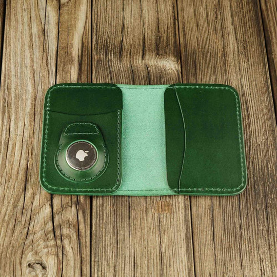 Green leather cardholder with slot on Apple AirTag slot, open