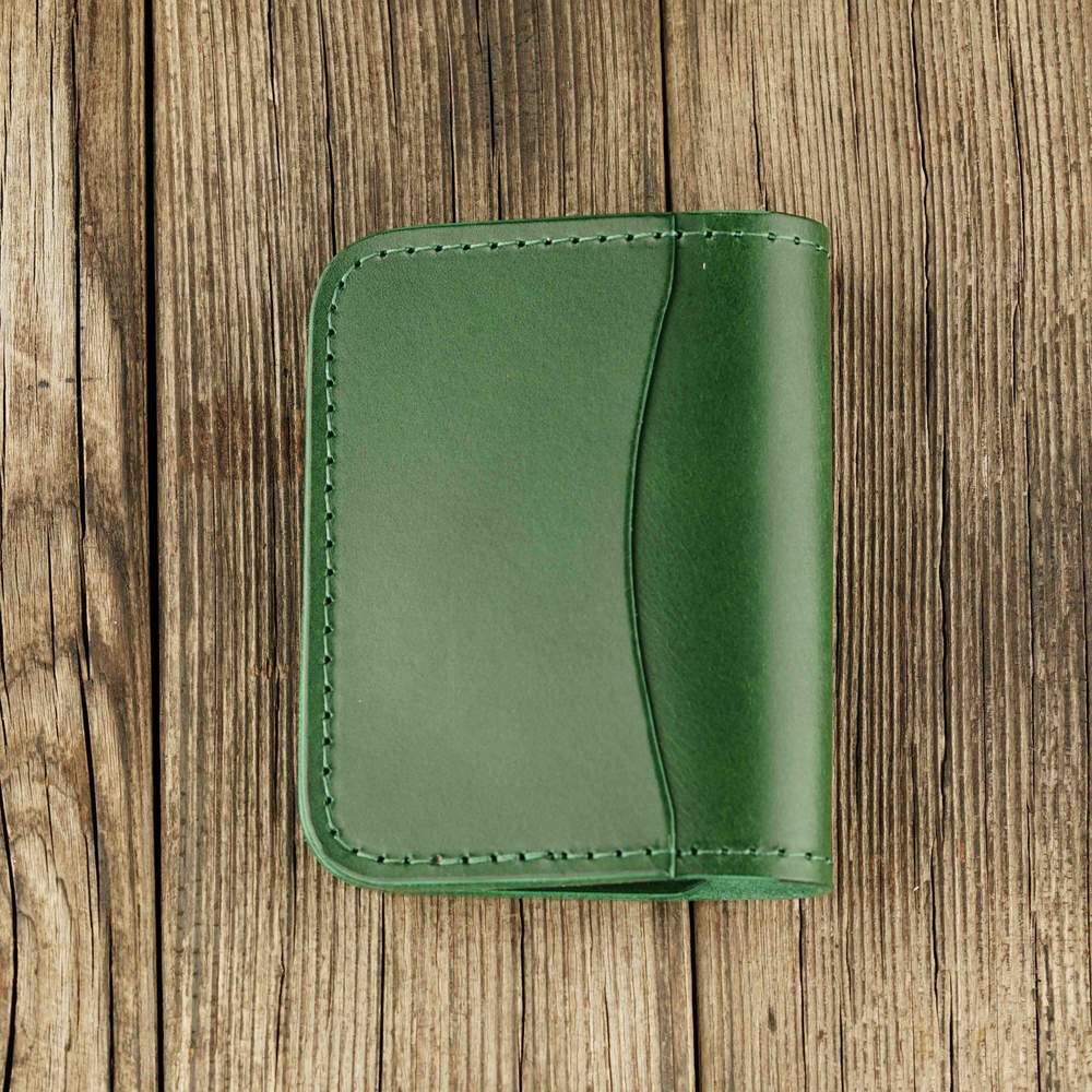Green leather cardholder with slot on Apple AirTag slot, back side
