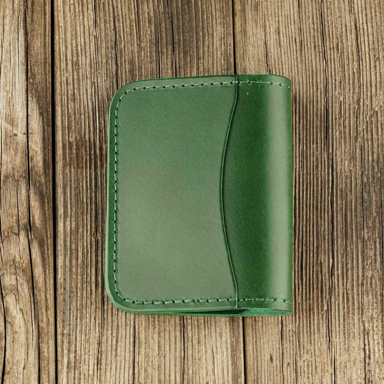 Green leather cardholder with slot on Apple AirTag slot, back side