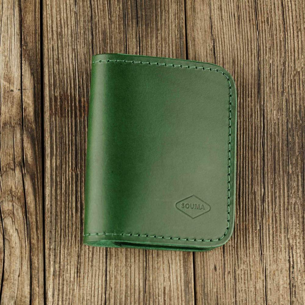Green leather bifold wallet with slot on Apple AirTag slot front view