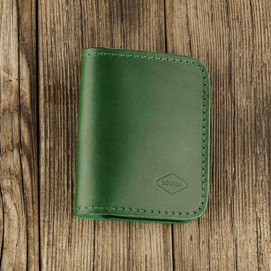 Green leather bifold wallet with slot on Apple AirTag slot front view