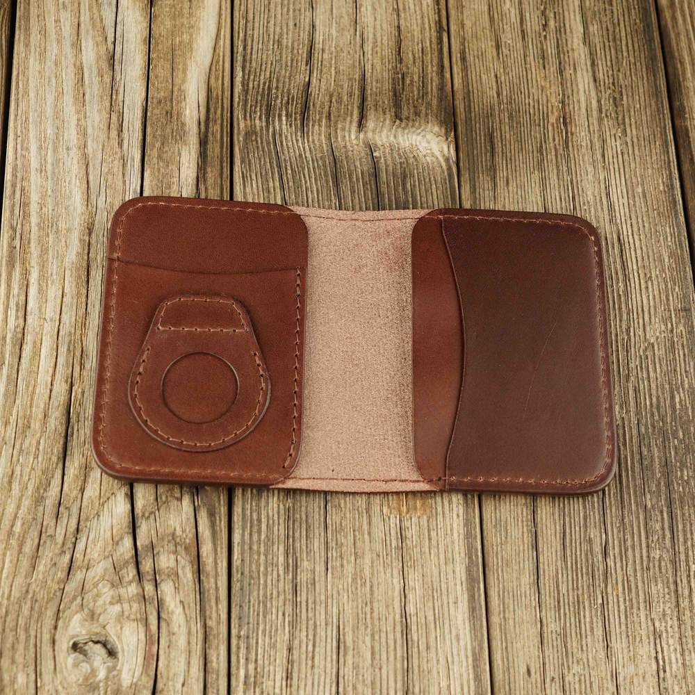 Brown leather bifold wallet with slot on Apple AirTag slot inside view without airtag