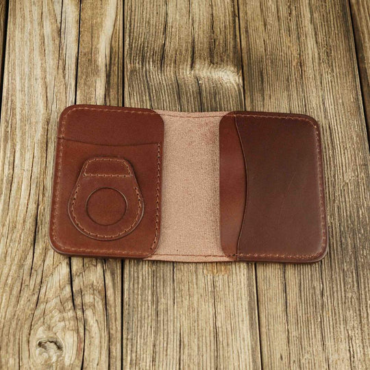 Brown leather bifold wallet with slot on Apple AirTag slot inside view without airtag