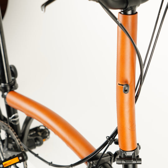 Full Frame Leather Protector Set for Brompton Bicycle - Velcro, close-up stem cover, honey color, main frame cover blurred 