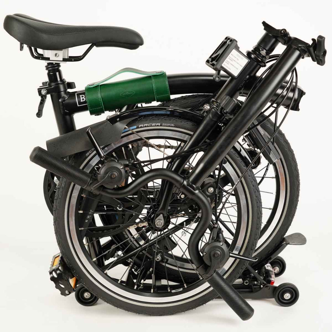 Green carry handle for Brompton on folded Brompton