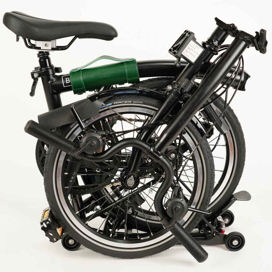 Green carry handle for Brompton on folded Brompton