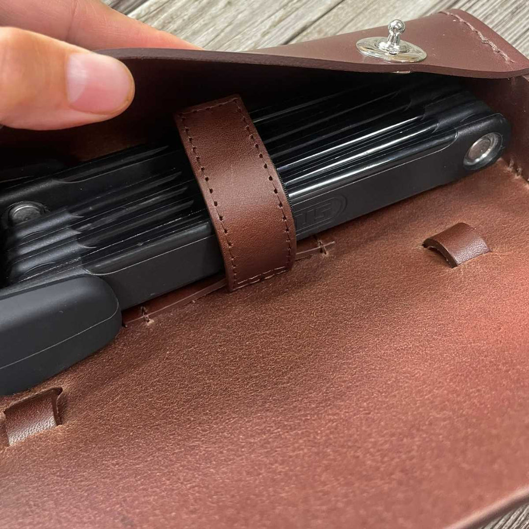 Close-up of a brown leather traditional saddle bag with strap for ABUS large