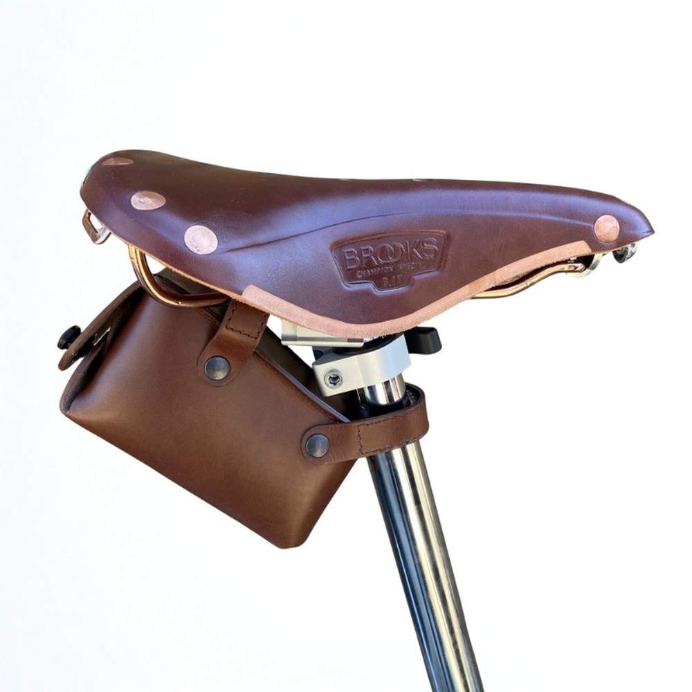 Brown leather bicycle saddle on Brooks saddle on a white background