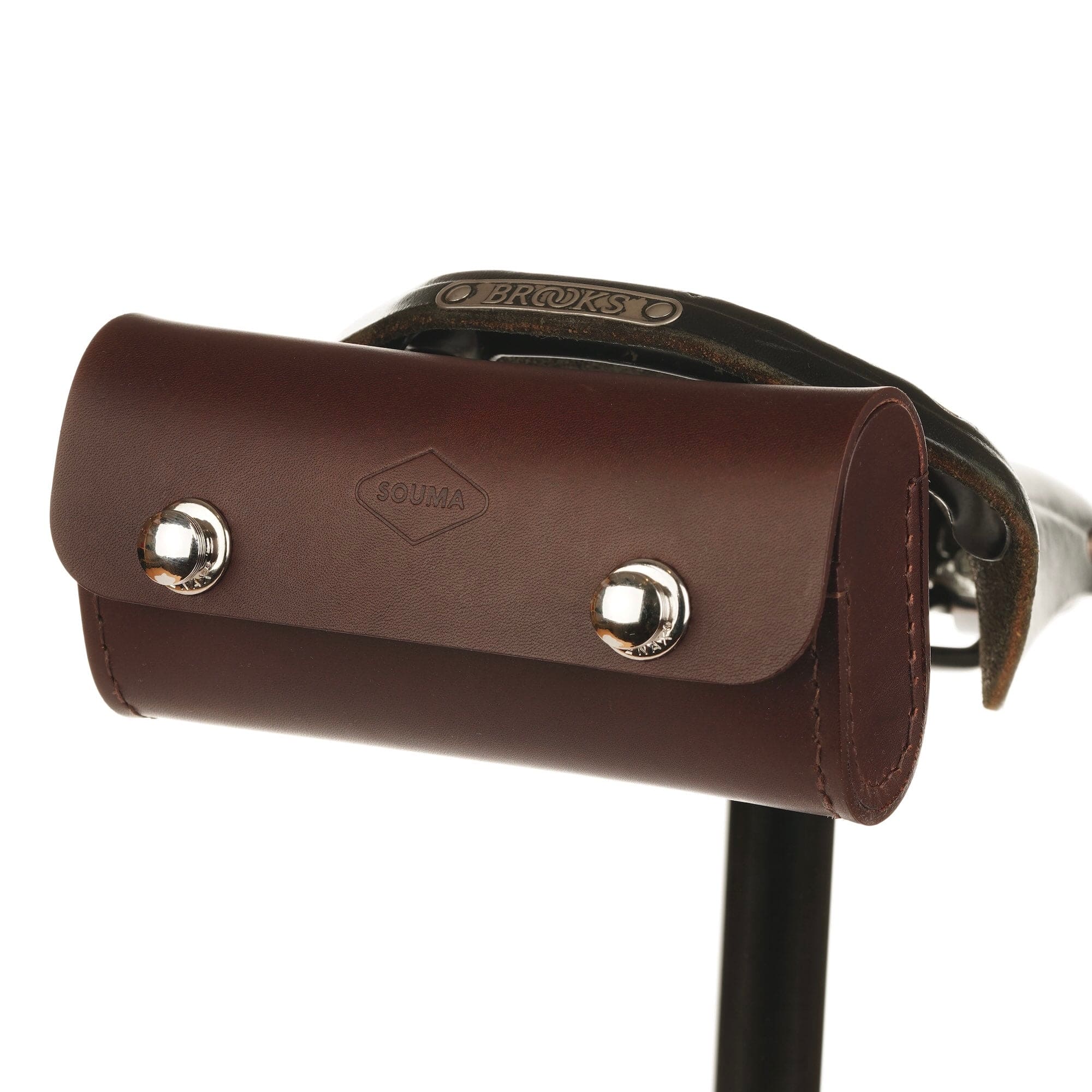 Brown leather saddle bag with silver studs on a white background