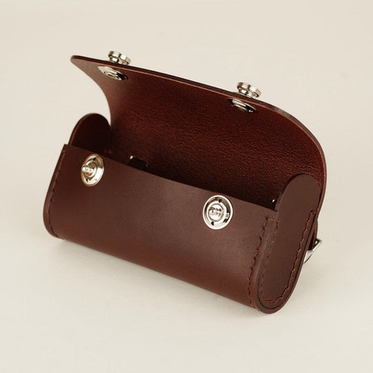 Brown leather bicycle saddle bag with silver buttons open