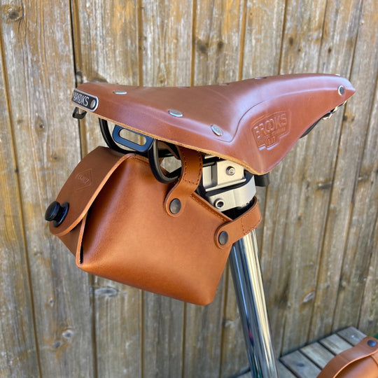 Leather Saddle Bag for Bicycles and Brompton bicycle Souma Leather honey color. black snaps, side view